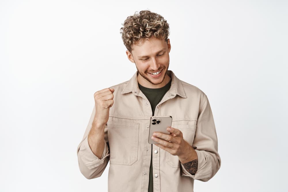 Person celebrating a successful international transfer on their phone