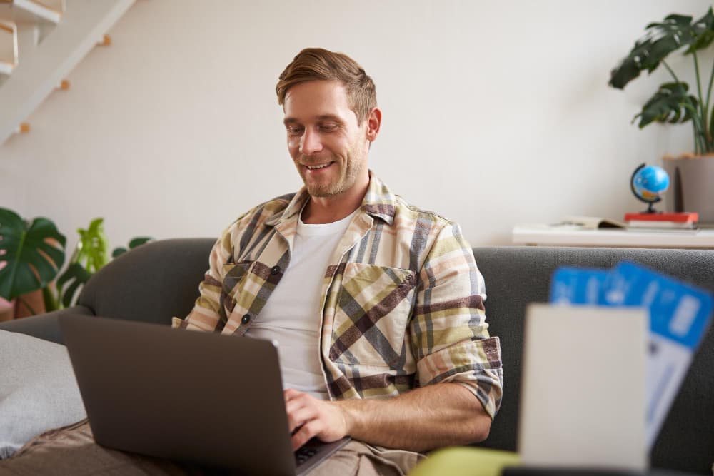 Person using a laptop at home to manage and track payments